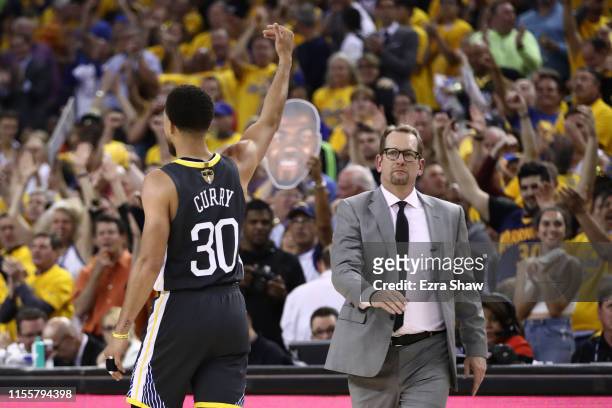 Head coach Nick Nurse of the Toronto Raptors looks on as Stephen Curry of the Golden State Warriors celebrates a basket in the first half during Game...