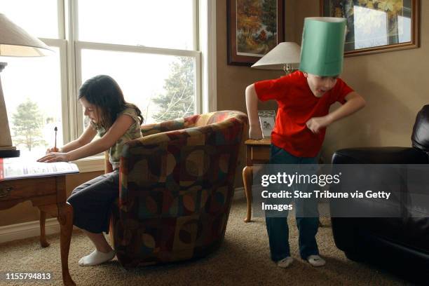 Jmcleister@startribune.com Woodbury,Mn.,Thurs.,March 15, 2007-- As Caroline Kieffer worked on her homework, her younger brother, Joe, played in the...