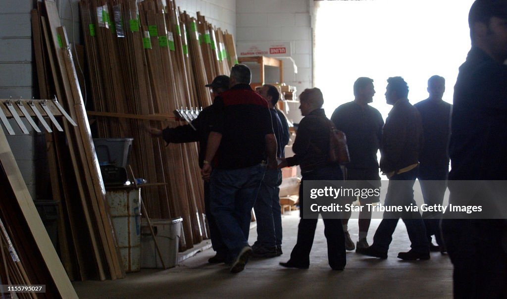 JOEY MCLEISTER ¬• jmcleister@startribune.com Eagan,Mn.,Sat.,April 21, 2007--Shoppers checked out trim and crown molding in the silent auction area of the Building Materials Outlet auction.  Bids were written on the clipboards.  In addition, there were f