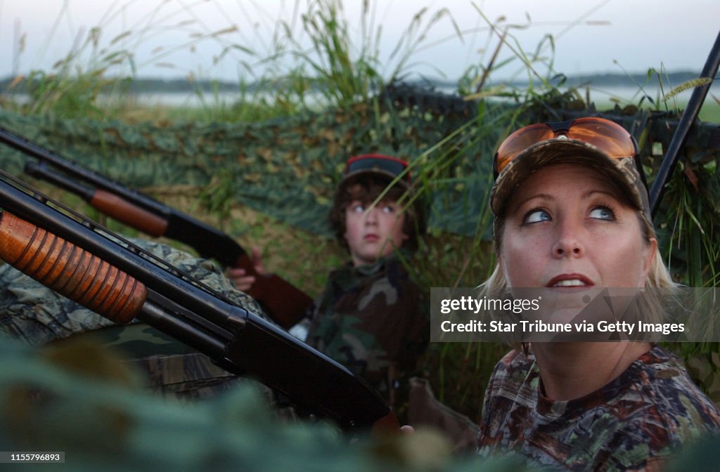 JOEY MCLEISTER ¥ jmcleister@startribune.com Lino Lakes,Mn.,Sat.,Sept. 1, 2007--(Left to right) Twelve-year-old Nicholas Flesland of Vadnais Heights and Christy Hurley of Marine on St. Croix watched for geese from their blind along the side of a sod fie