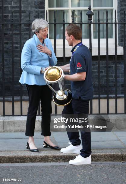 Prime Minister Theresa May with England cricket captain Eoin Morgan and the trophy outside Downing Street, London, ahead of a reception hosted by the...