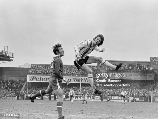 Mick Channon of Southampton rises above Ron Harris of Chelsea during an FA Cup 3rd Round tie at The Dell on January 8, 1977 in Southampton, England.