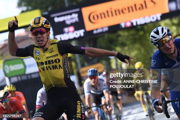 Belgium's Wout van Aert celebrates, past Italy's Elia Viviani, as he wins on the finish line of the tenth stage of the 106th edition of the Tour de...