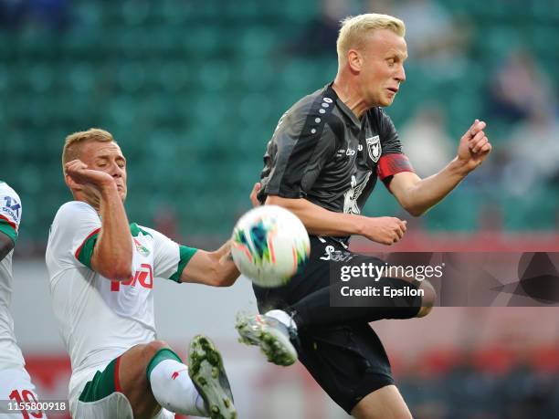 Dmitri Barinov of FC Lokomotiv Moscow and Vjacheslav Podberezkin of FC Rubin Kazan vie for the ball during the Russian Premier League match between...