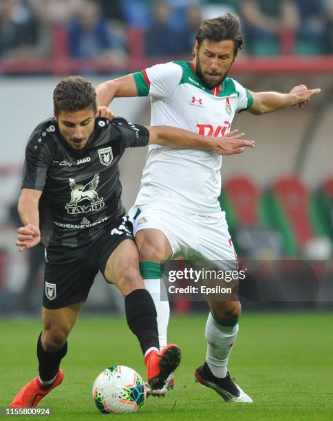 Grzegorz Krychowiak of FC Lokomotiv Moscow and Zuriko Davitashvili of FC Rubin Kazan vie for the ball during the Russian Premier League match between...