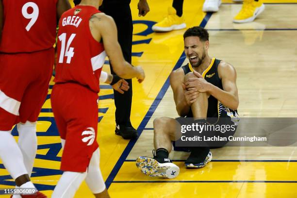 Klay Thompson of the Golden State Warriors reacts after hurting his leg against the Toronto Raptors in the second half during Game Six of the 2019...