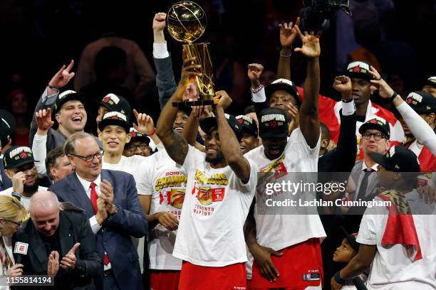 Kawhi Leonard of the Toronto Raptors celebrates with the Larry O'Brien Championship Trophy after his team defeated the Golden State Warriors to win...