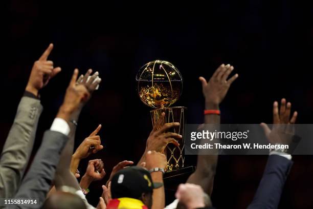 The Toronto Raptors celebrate with the Larry O'Brien Championship Trophy after defeating the Golden State Warriors to win Game Six of the 2019 NBA...