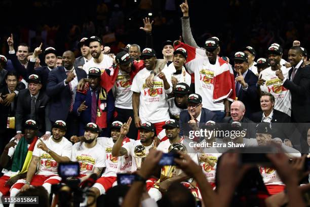 The Toronto Raptors celebrate with the Larry O'Brien Championship Trophy after their team defeated the Golden State Warriors to win Game Six of the...