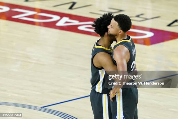 Quinn Cook and Stephen Curry of the Golden State Warriors embrace late in the game against the Toronto Raptors during Game Six of the 2019 NBA Finals...