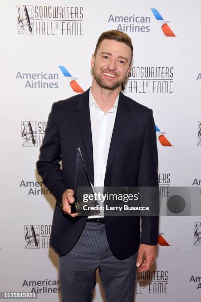 Justin Timberlake poses with the Contemporary Icon Award backstage during the Songwriters Hall Of Fame 50th Annual Induction And Awards Dinner at The...