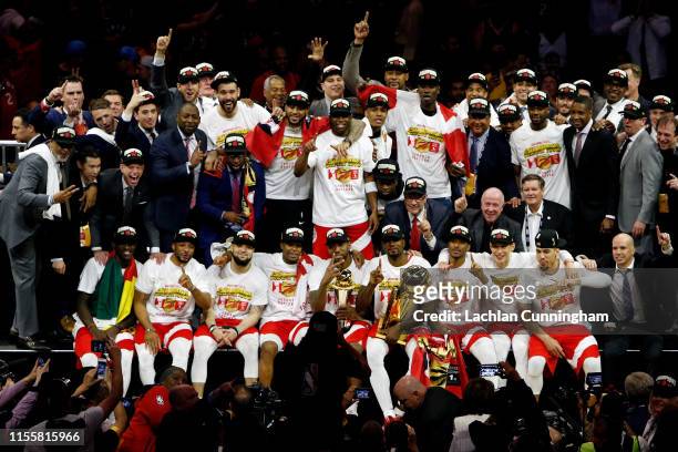 The Toronto Raptors pose for a photo after their team defeated the Golden State Warriors to win Game Six of the 2019 NBA Finals at ORACLE Arena on...