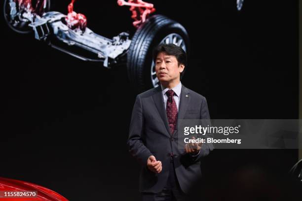 Kunio Nakaguro, executive vice president of Nissan Motor Co., speaks during a launch of the company's Skyline GT vehicle at the company's...