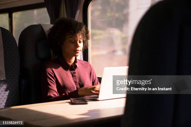 young woman riding on a train - pendler bahn stock-fotos und bilder