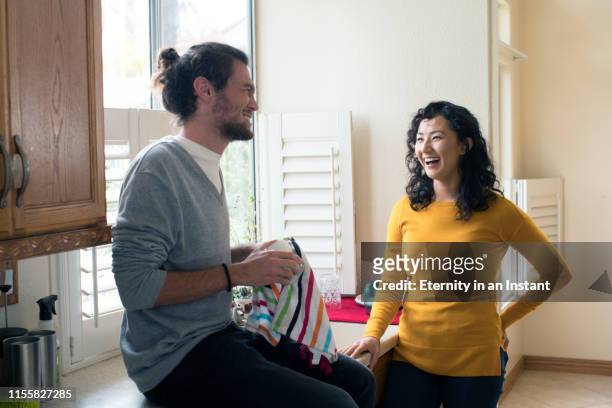 young couple doing the dishes together - the japanese wife stock pictures, royalty-free photos & images