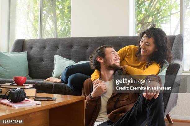 cool couple hanging out at home - middle eastern ethnicity stock pictures, royalty-free photos & images