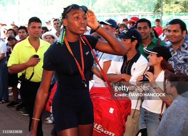 American Serena Williams walks past rows of fans on her way into the White City Stadium in Sydney 10 January. Williams is in here to compete in the...