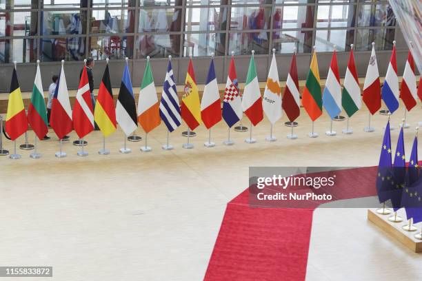 Flags and flags of the European countries state member next to the red carpet where EU leaders arrive in the EU in the European Council building...