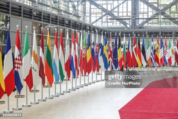 Flags and flags of the European countries state member next to the red carpet where EU leaders arrive in the EU in the European Council building...