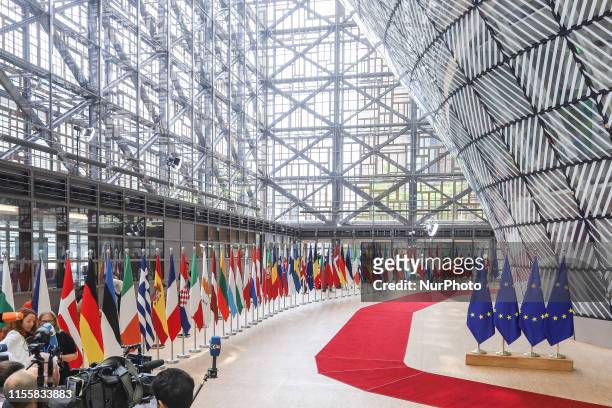 Flags and flags of the European countries state member next to the red carpet where EU leaders arrive in the EU in the European Council building...