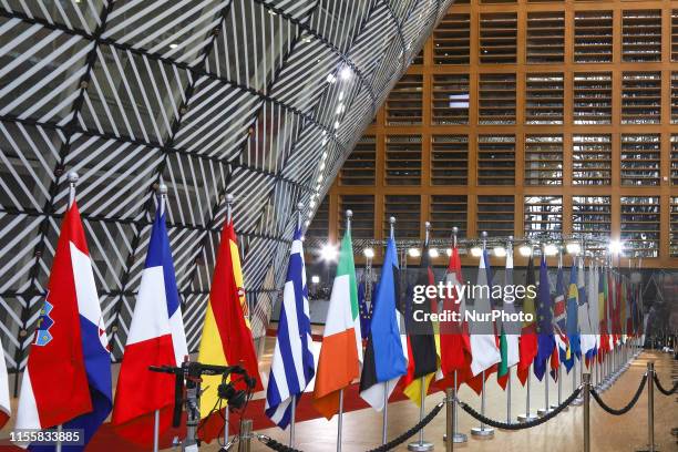 Flags and flags of the European countries state member next to the red carpet where EU leaders arrive in the EU in the European Council building...