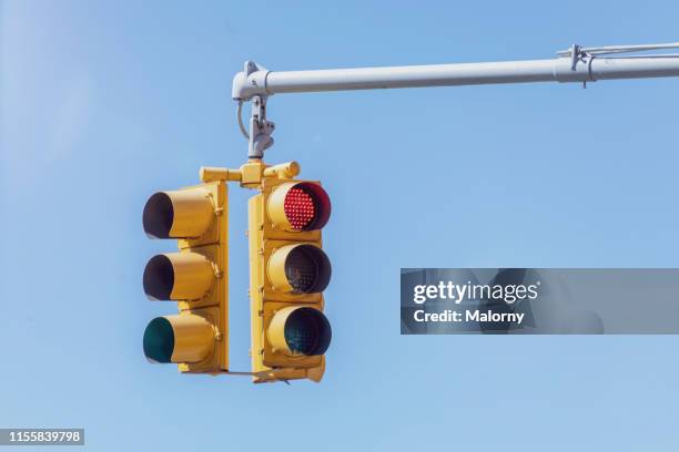 traffic lights against blue sky. - red light stock-fotos und bilder