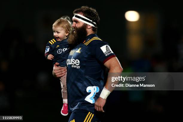 Liam Coltman runs out on field for his 100th Super Rugby match for the Highlanders during the round 18 Super Rugby match between the Highlanders and...
