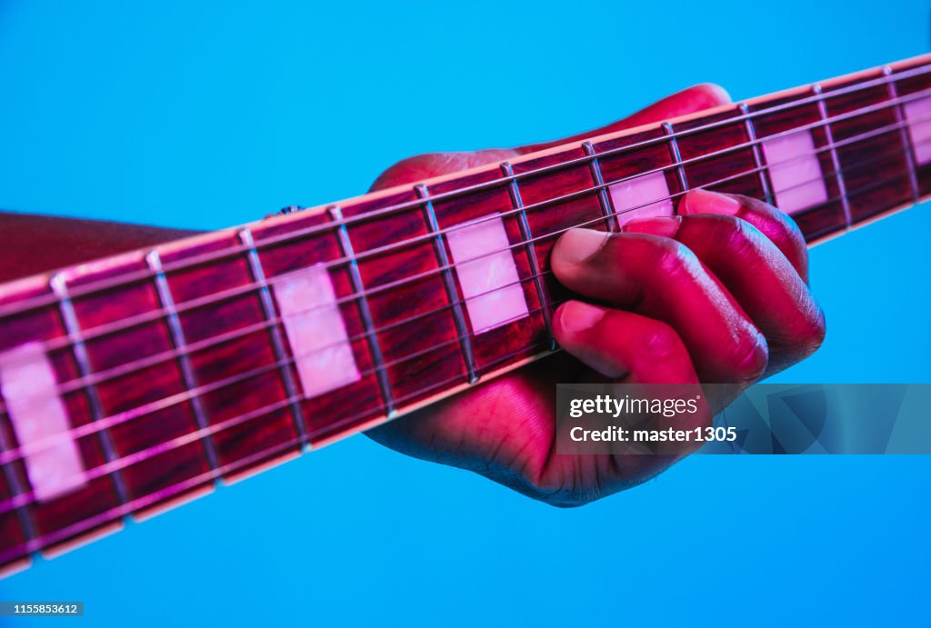 Young african-american jazz musician playing the guitar