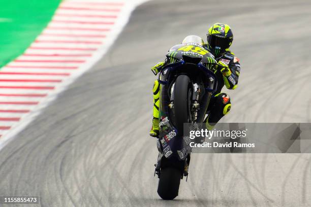 Valentino Rossi of Italy and Monster Energy Yamaha MotoGP pulls a wheelie after the first MotoGP free practice session ahead of MotoGP Gran Premi...