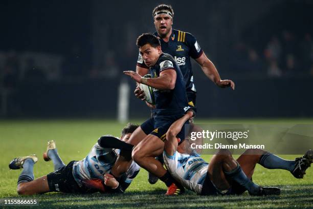 Rob Thompson of the Highlanders is tackled by Adam Ashley-Cooper and Nick Phipps of the Waratahs during the round 18 Super Rugby match between the...