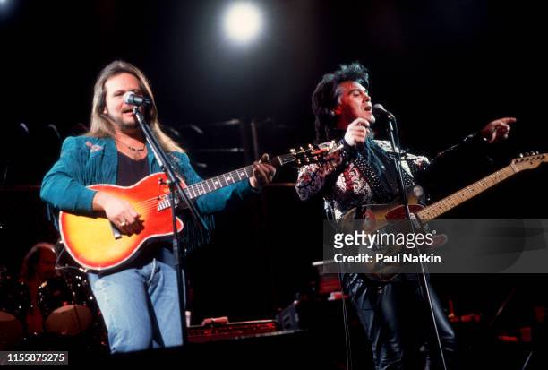 American Country musicians Travis Tritt and Marty Stuart play guitars as they perform onstage at the Holiday Star Theater, Merillville, Indiana,...