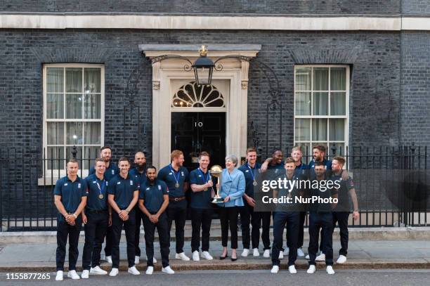 Prime Minister Theresa May and Eoin Morgan hold the trophy outside 10 Downing Street as the England Mens Cricket team pose for a group photo...