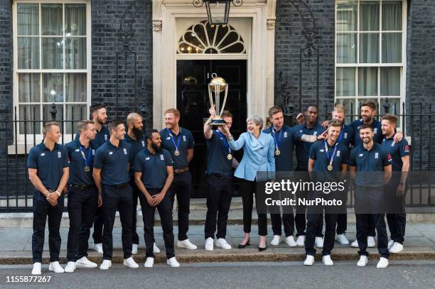 Prime Minister Theresa May and Eoin Morgan lift the trophy outside 10 Downing Street as the England Mens Cricket team pose for a group photo...