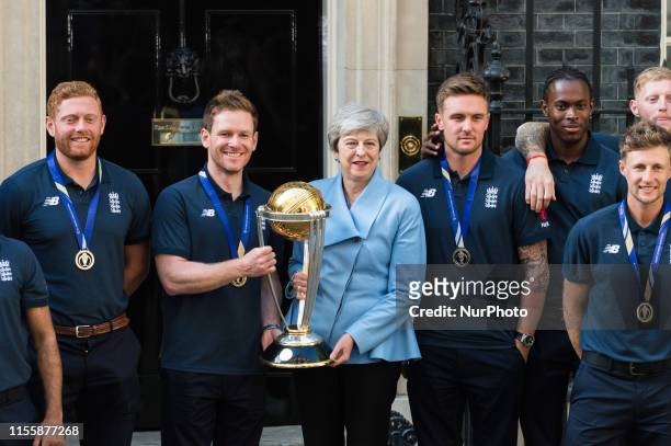 Prime Minister Theresa May and Eoin Morgan hold the trophy outside 10 Downing Street as the England Mens Cricket team pose for a group photo...