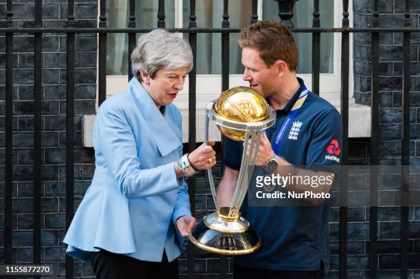 England Mens Cricket team captain Eoin Morgan shows the trophy to Prime Minister Theresa May outside 10 Downing Street as the team arrives to...