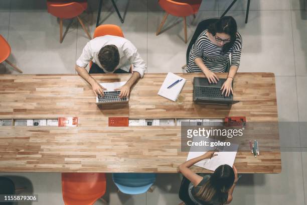 business people working on desk - co working space stock pictures, royalty-free photos & images