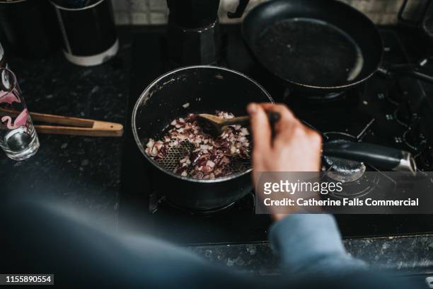 browning onions - hands cooking stock pictures, royalty-free photos & images
