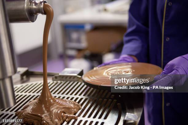 Cadbury World chocolatier Dawn Jenks adds the finishing touches to the chocolate recreation of the Apollo 11 moon landing at Cadbury World in...