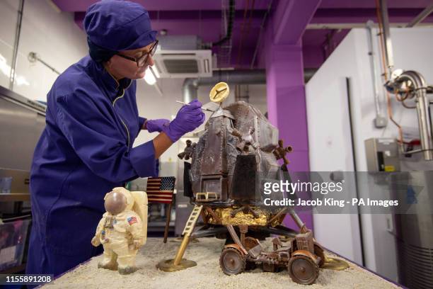 Cadbury World chocolatier Dawn Jenks adds the finishing touches to the chocolate recreation of the Apollo 11 moon landing at Cadbury World in...