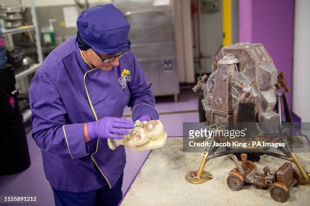 Cadbury World chocolatier Donna Oluban adds the finishing touches to the chocolate recreation of the Apollo 11 moon landing at Cadbury World in...