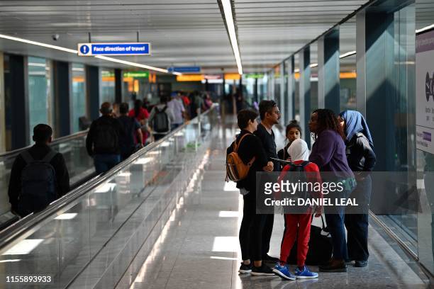 Family are asked questions about forced marriage by officials and a member of UK Border Force after landing from Bangalore in India, in Terminal 2 at...