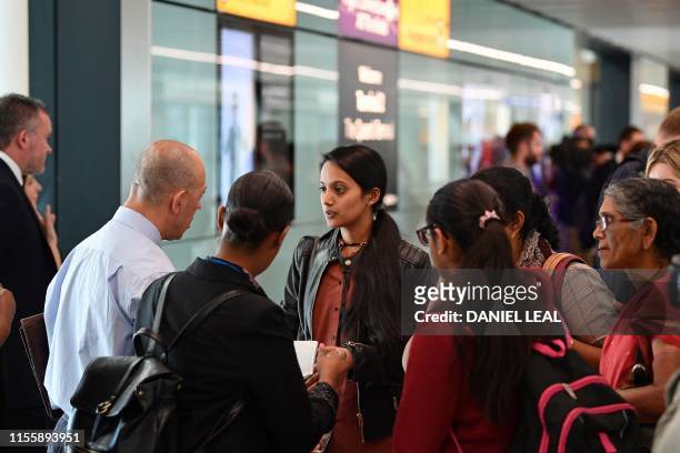 Family are asked questions about forced marriage by officials and a member of UK Border Force after landing from Bangalore in India, in Terminal 2 at...