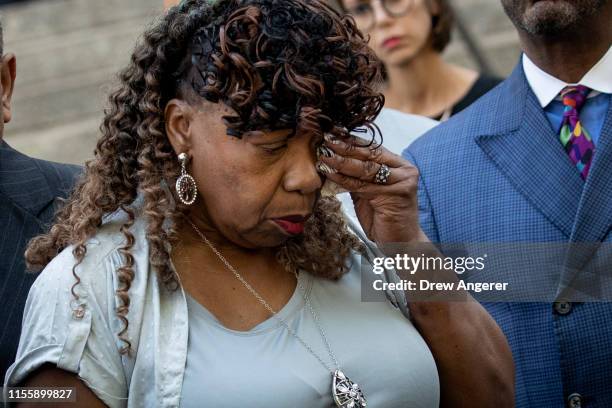 Gwen Carr, mother of the late Eric Garner, wipes away tears after speaking to the press outside the U.S. Attorney's office following a meeting with...