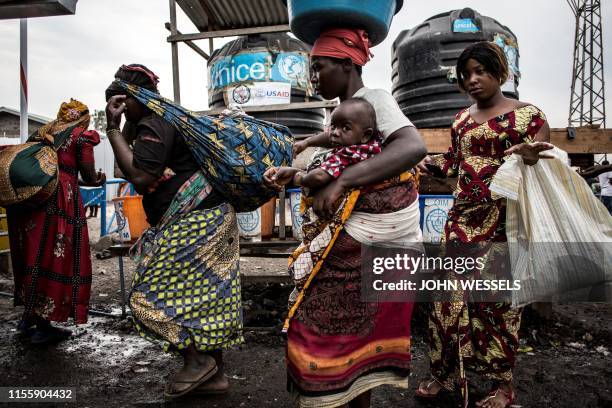 Women are seen washing their hands at an Ebola screening station as they enter the Democratic Republic of the Congo from Rwanda on July 16, 2019 in...