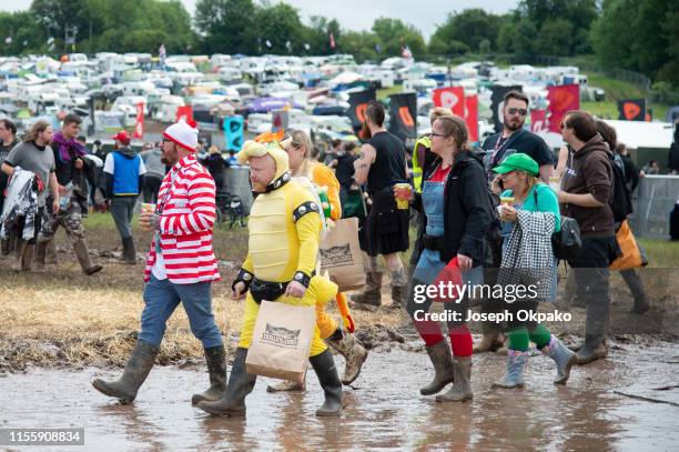 Festival goers brave the muddy fields during day 1 at Download festival 2019 at Donington Park on June 14, 2019 in Castle Donington, England.