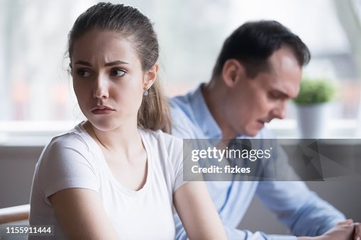 Millennial couple after fight at home ignoring each other Millennial couple after fight at home ignoring each other