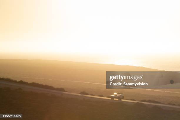 road trip on the coastline highway against sunset - エクソマス ストックフォトと画像