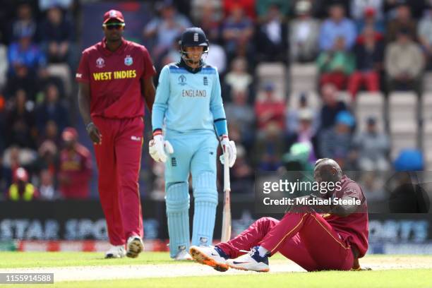 Andre Russell of West Indies lies on the wicket after injuring himself bowling during the Group Stage match of the ICC Cricket World Cup 2019 between...