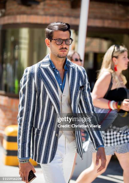 Guest is seen wearing striped blazer during Pitti Immagine Uomo 96 on June 13, 2019 in Florence, Italy.