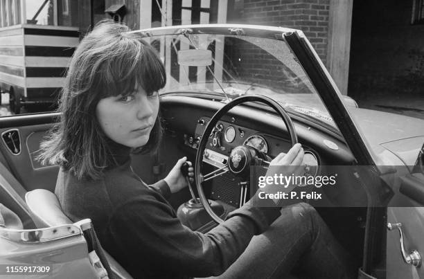 British actress Lucy Fleming on the driver seat of a convertible car, UK, 12th April 1965.